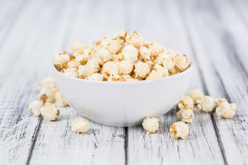 Popcorn on wooden background; selective focus