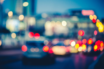 Multicolored bokeh of cars at rush hour in Milan city urban area - Defocused traffic jam in highway intersection - Transport concept with blurred vehicles at night - Dark vivid color tones filter

