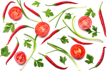 mix red hot chili peppers with parsley and sliced tomato isolated on white background top view