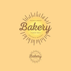 The bakery logo. Morning pastries and bread emblems. Letters and the sun on a light background