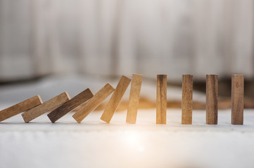 domino effect made up from wooden blocks shape toy.domino effect in business concept.the domino wooden effect concept for business.