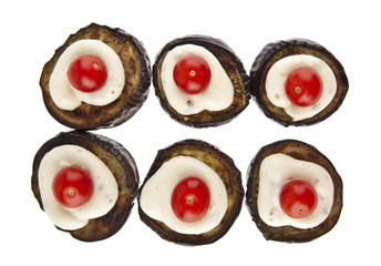 fried eggplant with sauce and a red tomato isolated on white background closeup