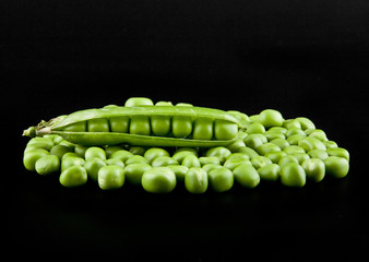 Green peas on a black background