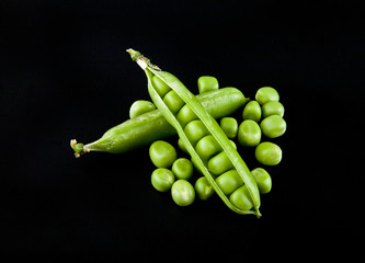 Green peas on a black background