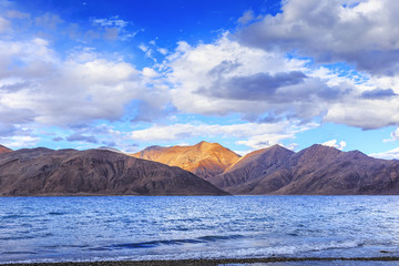 Fototapeta na wymiar Pangong tso (Lake). It is huge lake in Ladakh, altitude 4,350 m (14,270 ft). It is 134 km (83 mi) long and extends from India to Tibet. Leh, Ladakh, Jammu and Kashmir, India.