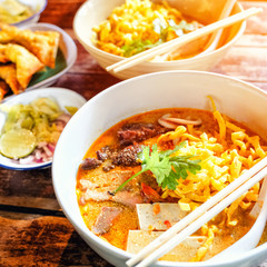 Northern Thai curried noodle soup with chicken meat and spicy coconut milk (Khao Soi Kai)