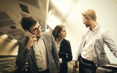 Coworkers using subway stairs together