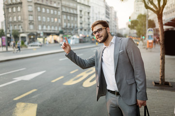 Business men hailing a cab in busy city