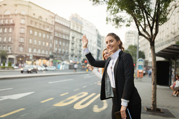 Businesswoman waving for a cab