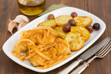 fried cod fish with onion and olive oil on dish