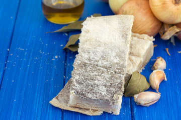 dry cod fish with onion on wooden background
