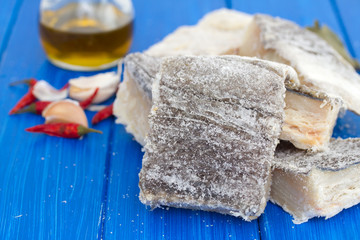 salted dry codfish on wooden background