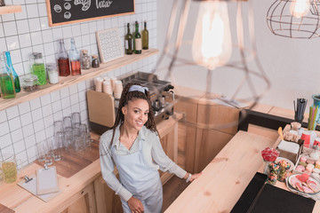 barista standing behind counter