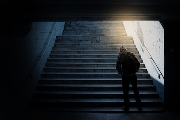 Loneliness man standing back in subway underground crossing