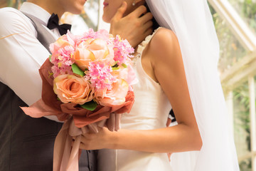 Obraz na płótnie Canvas Close-up Bride and groom holding bouquet, Love and romance, ,Wedding Concept.