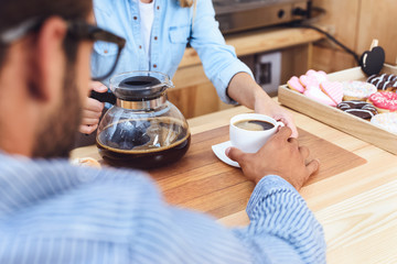 waitress pouring coffee to client