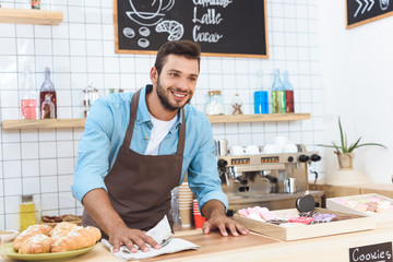 barista cleaning bar counter