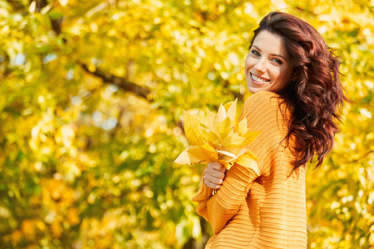 Autumn woman in autumn park. Warm sunny weather. Fall concept