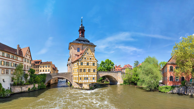 Bamberg. Panoramic view of Old Town Hall of Bamberg (Altes Rathaus) with two bridges over the Regnitz river, Bavaria, Germany
