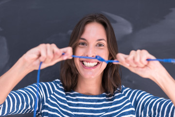 woman holding a internet cable in front of chalk drawing board