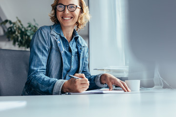 Smiling businesswoman working in office