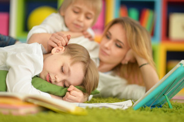 Obraz premium mother and sons doing homework