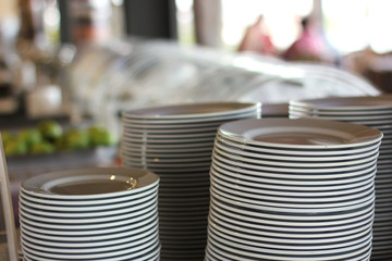 Fototapeta premium Piles of white plates in a restaurant