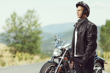 Biker standing in front of a motorcycle