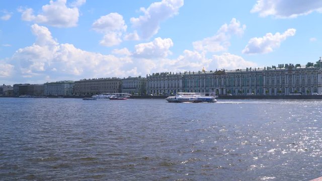 Pleasure boat floats in front of the Hermitage building