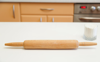 In the interior of the kitchen. To prepare the cake take the flour and cranberries. Hands in the background. Kitchenware. Cook food.