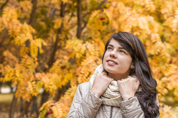 Girl against the background of autumn foliage