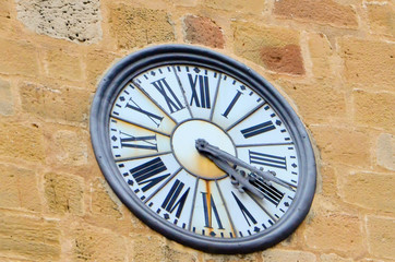 the old wall clock with Roman numerals