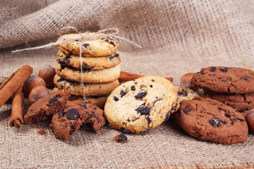 Delicious cookie with chocolate, cinnamon and nut lying on the table in the home.
