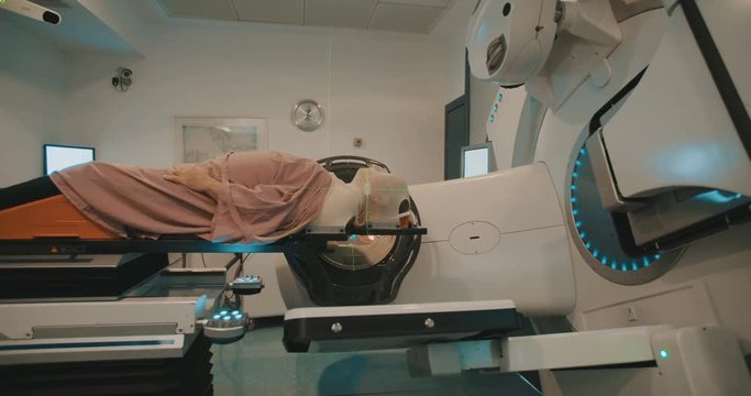 Patient getting Radiation Therapy Treatment inside a large radiotherapy room