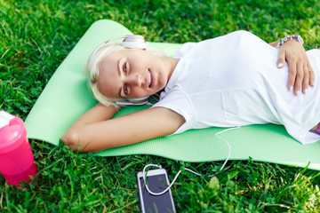 Image of woman in headphones on rug