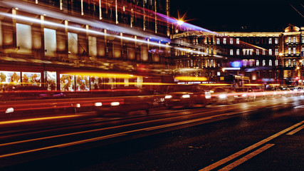 Fototapeta na wymiar Blurred night traffic. Light trails on the road at night on Kamennoostrovskiy prospect in Saint-Petersburg, Russia