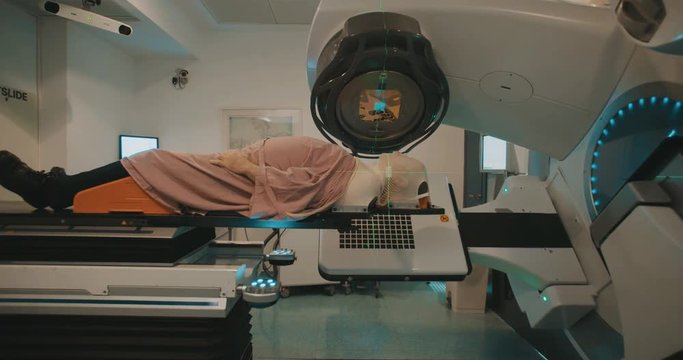 Patient getting Radiation Therapy Treatment inside a modern radiotherapy room