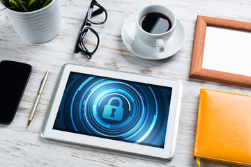 Web security and technology concept with tablet pc on wooden table