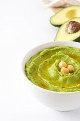Avocado hummus in bowl isolated on white background