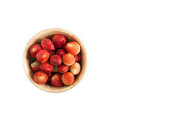 Strawberries in a wooden bowl on white background