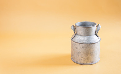 Water cans made of tin on yellow background