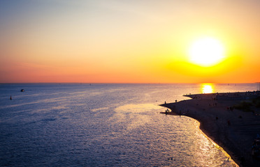 Fototapeta na wymiar A twisting line of sea coast at sunset as background