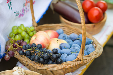 plums, grapes and apples in the basket