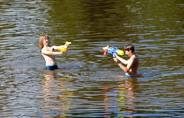 Two Boys Fighting with Squirt Guns.