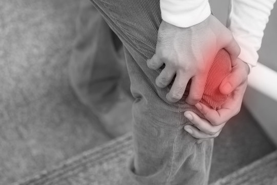 man hand holding knee joint pain, excessive weight carrying concept