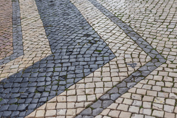 An ancient Portuguese paving stone on streets of Faro.