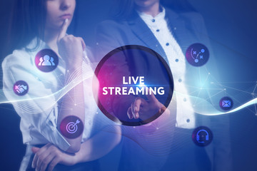 The concept of business, technology, the Internet and the network. A team of business women working on the virtual screen of the future and see the inscription: Live streaming