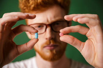 Close up portrait of a concentrated redhead man