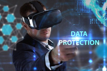 Business, Technology, Internet and network concept. Young businessman working in virtual reality glasses sees the inscription: Data protection
