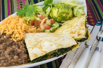 Spinach mushroom quesadillas with refried beans and rice.